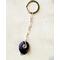 Deep purple natural Amethyst keychain with silver wire wrap, shown on white leather background 
